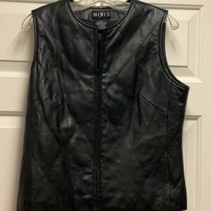 Black leather vest withh a quilted design. Size 8 and excellent condition.